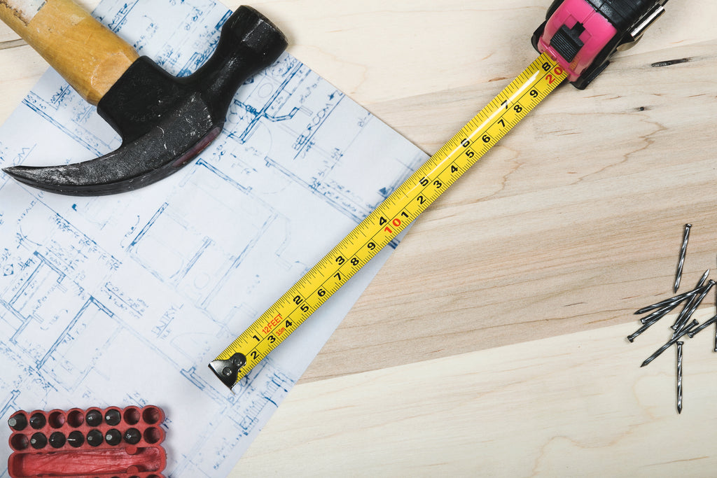 A hammer ruler and blueprints for roofing industry training 